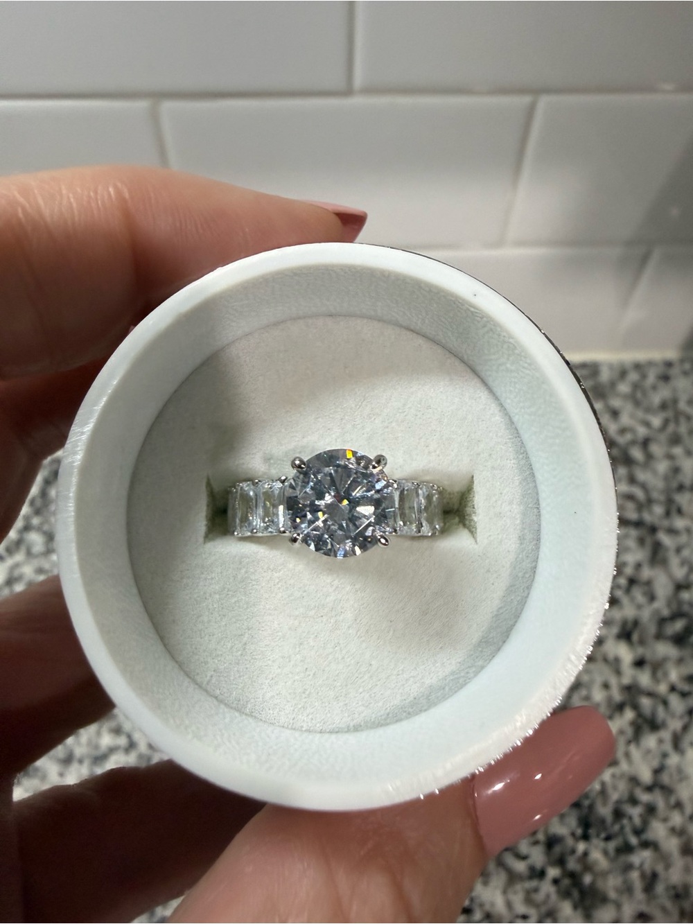 Round-Cut Silver Engagement Ring with Side Baguette Stones. Cubic Zirconia